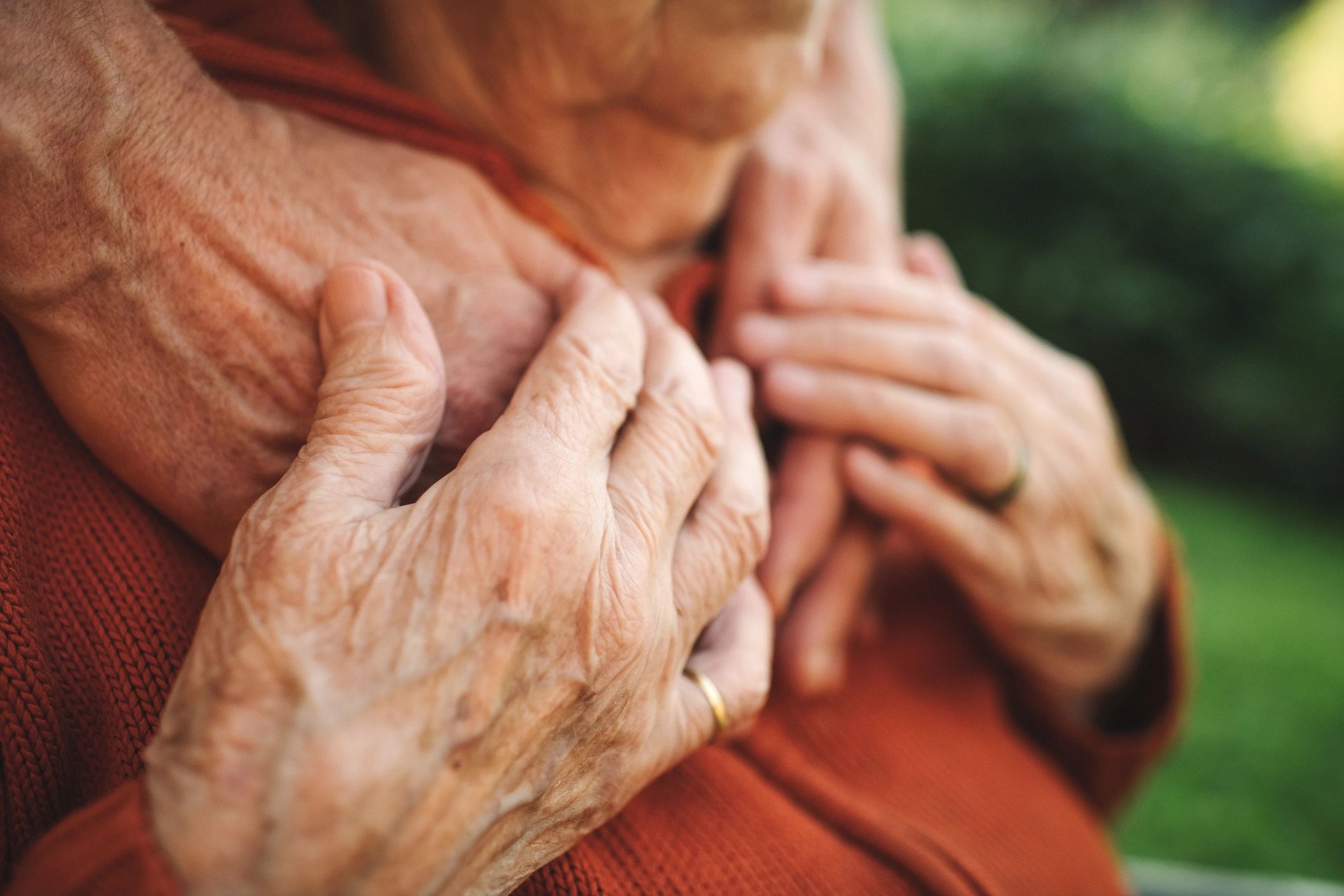 compassionate female carer helping elderly man at home