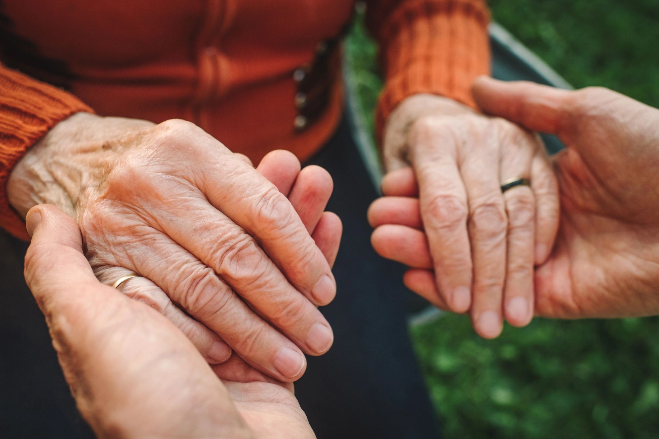 compassionate female carer helping elderly man at home